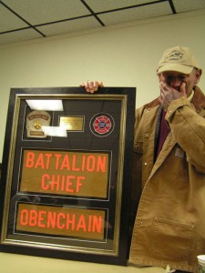 Retirement Dinner: Billy stands with his framed memorobilia